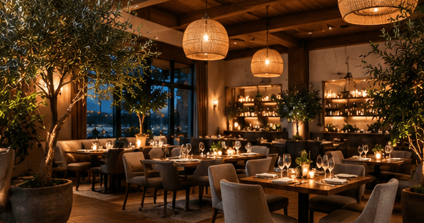 The main dining room with warm pendant lights and plants.